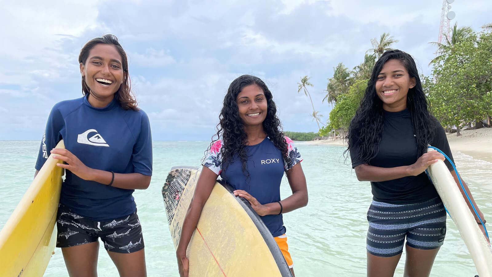 Portrait of female surfers Naha Nasrulla, Aya Naseem and Rishtha Shuja in the Maldives