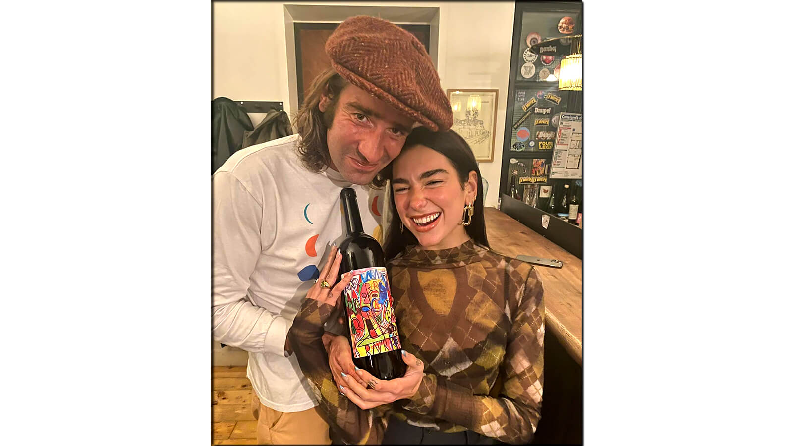 Image of Dua Lipa and Clovis Ochin with a bottle of natural wine