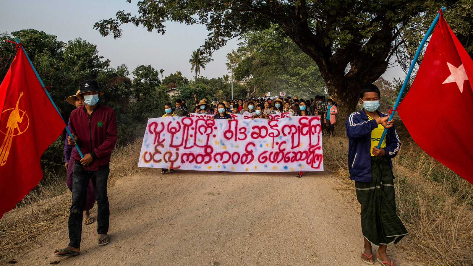 Image of protesters in Myanmar marching during a demonstration against the military coup