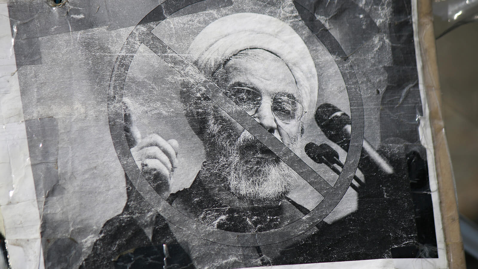 Image of protest poster featuring former Iranian president Hassan Rouhani who was in power from 2013 to 2021