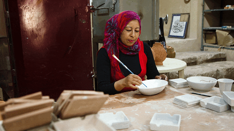 Images of women cooking and making crafts at the Iraq Al-Amir Women's Co-Operative