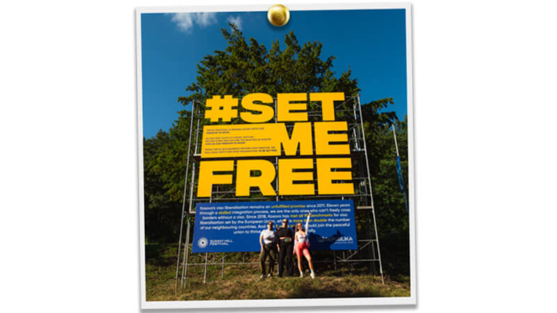 Image of people in front of the Set Me Free campaign installation at Sunny Hill Festival, Kosovo