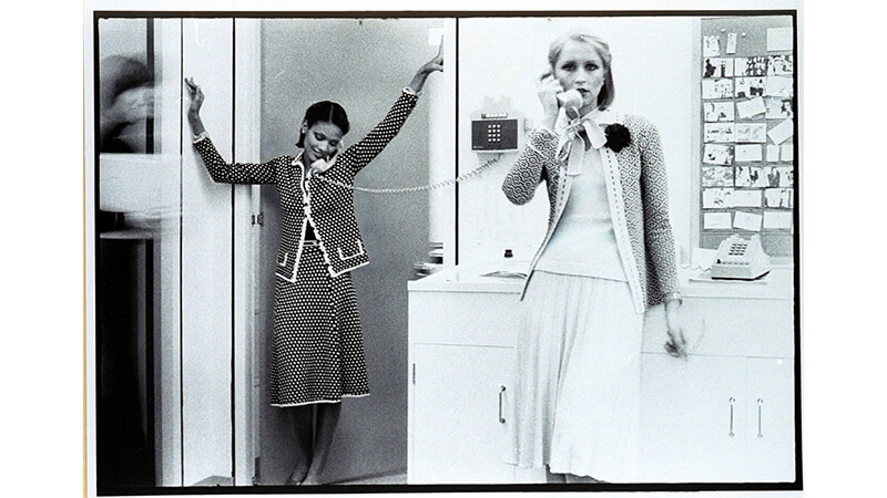 Black and white image of two women speaking on the telephone