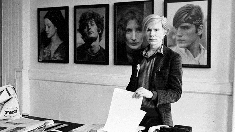 Portrait of Andy Warhol, images of textile prints designed by Warhol, installation of the Andy Warhol: The Textiles Exhibition at the Fashion And Textiles Museum, London