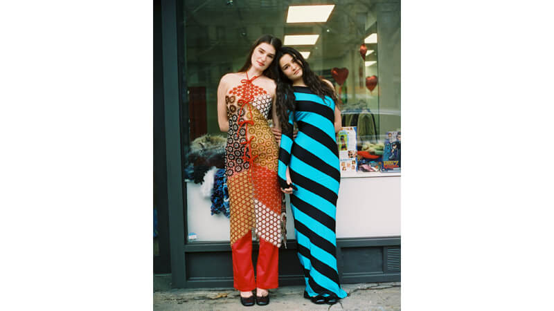 Image of two girls wearing vintage clothing outside New York store Tired Thrift