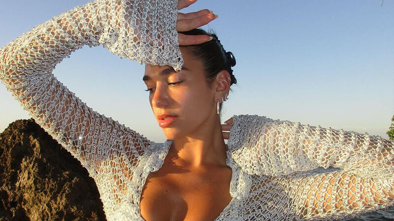 Dua Lipa summer beauty: image of Dua wearing a white crochet top