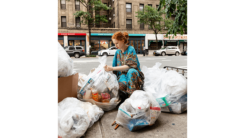 The Trash Walker, AKA Anna Sacks searching through rubbish on the streets of New York