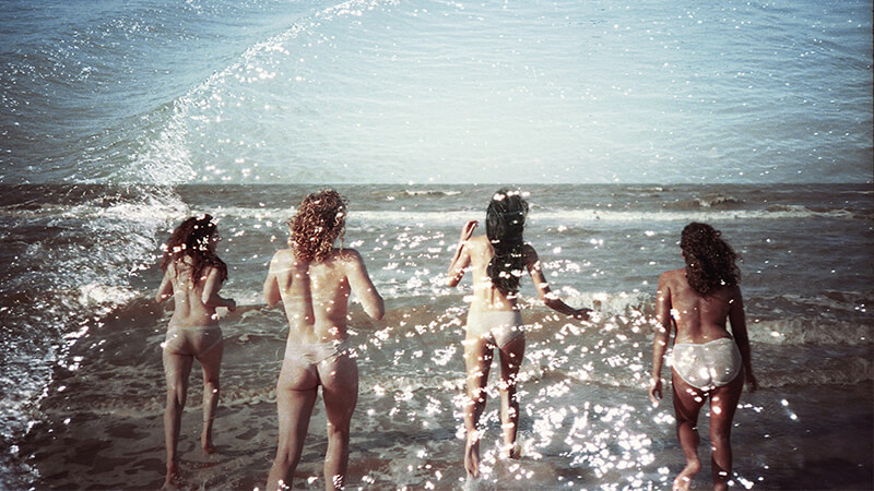 Women running into the sea