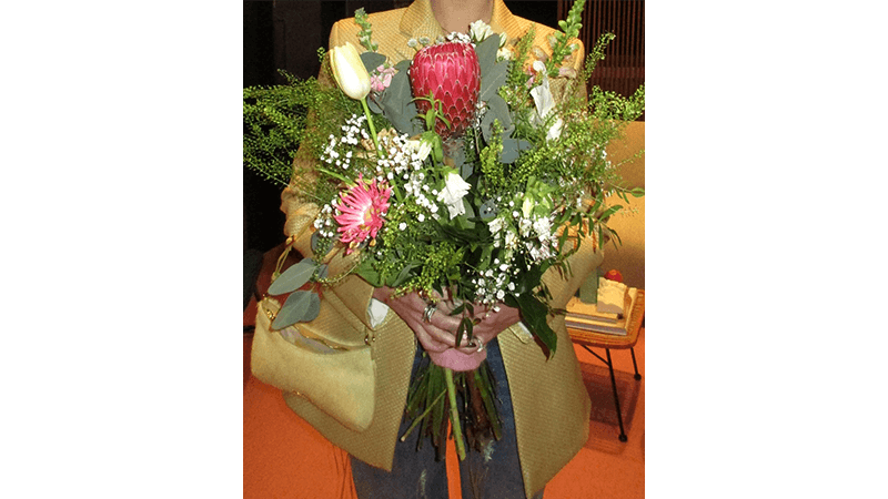 Dua Lipa holding large bunch of flowers