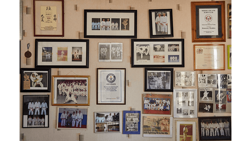 A wall of Judo awards, competition photography and memorabilia in the home of centenarian Jack, for the 100th issue of Service95